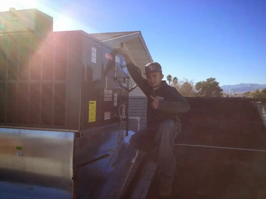 HVAC technician performing AC Tune-Up on a rooftop unit in Buckeye